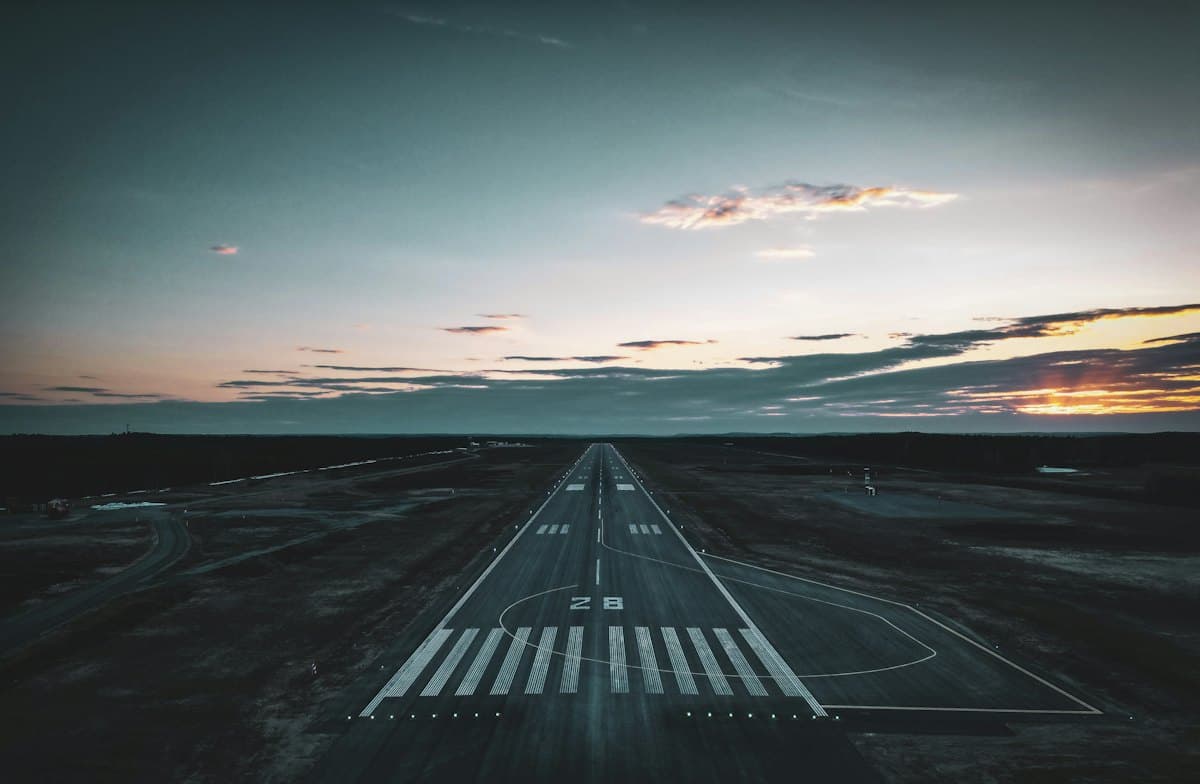 An airport runway at sunset