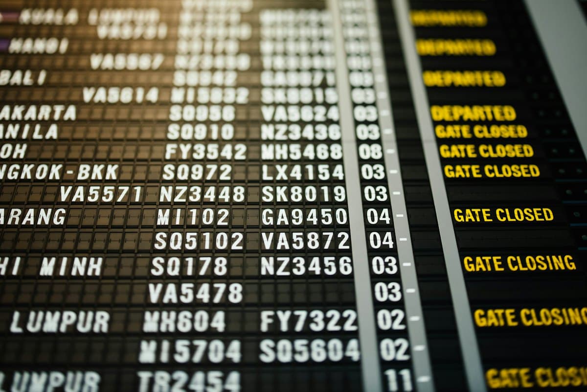 An airport departures board showing gates closing