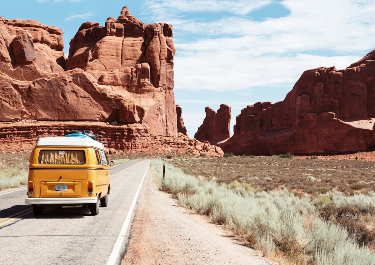 A passenger van on a desert highway