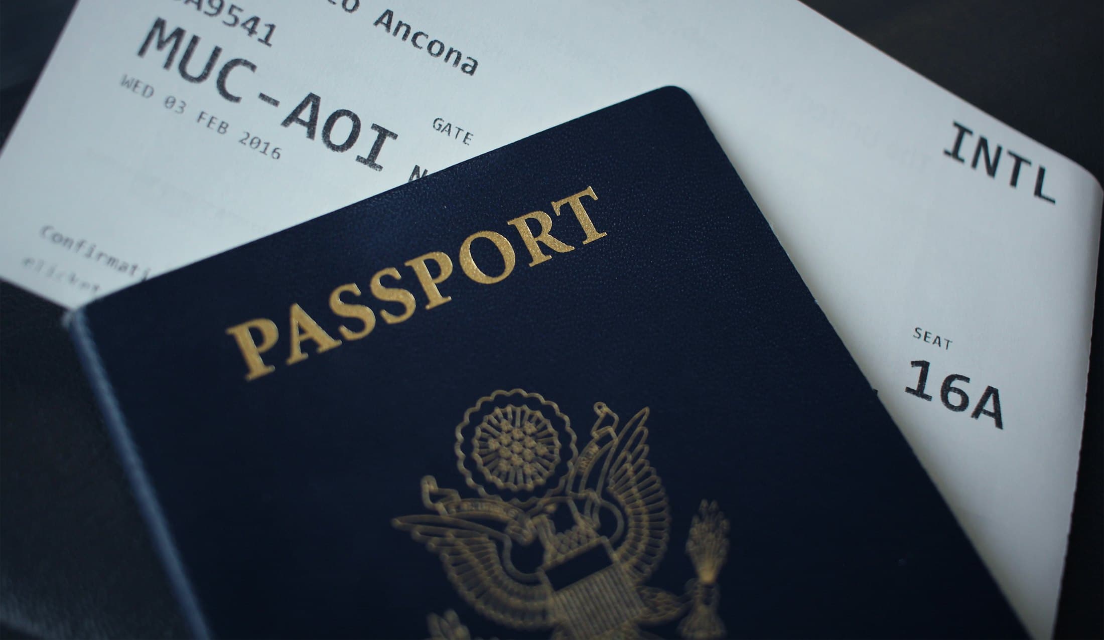 A passport resting on a boarding pass