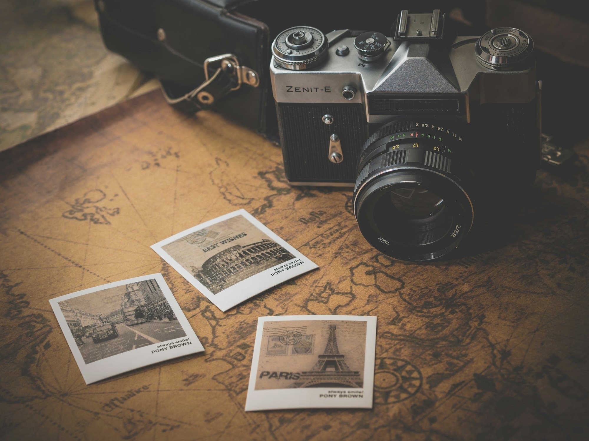 A camera and printed photos on a travel map