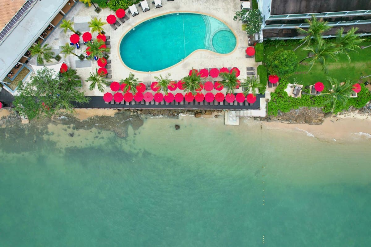 Aerial view of a beachfront resort with a turquoise pool