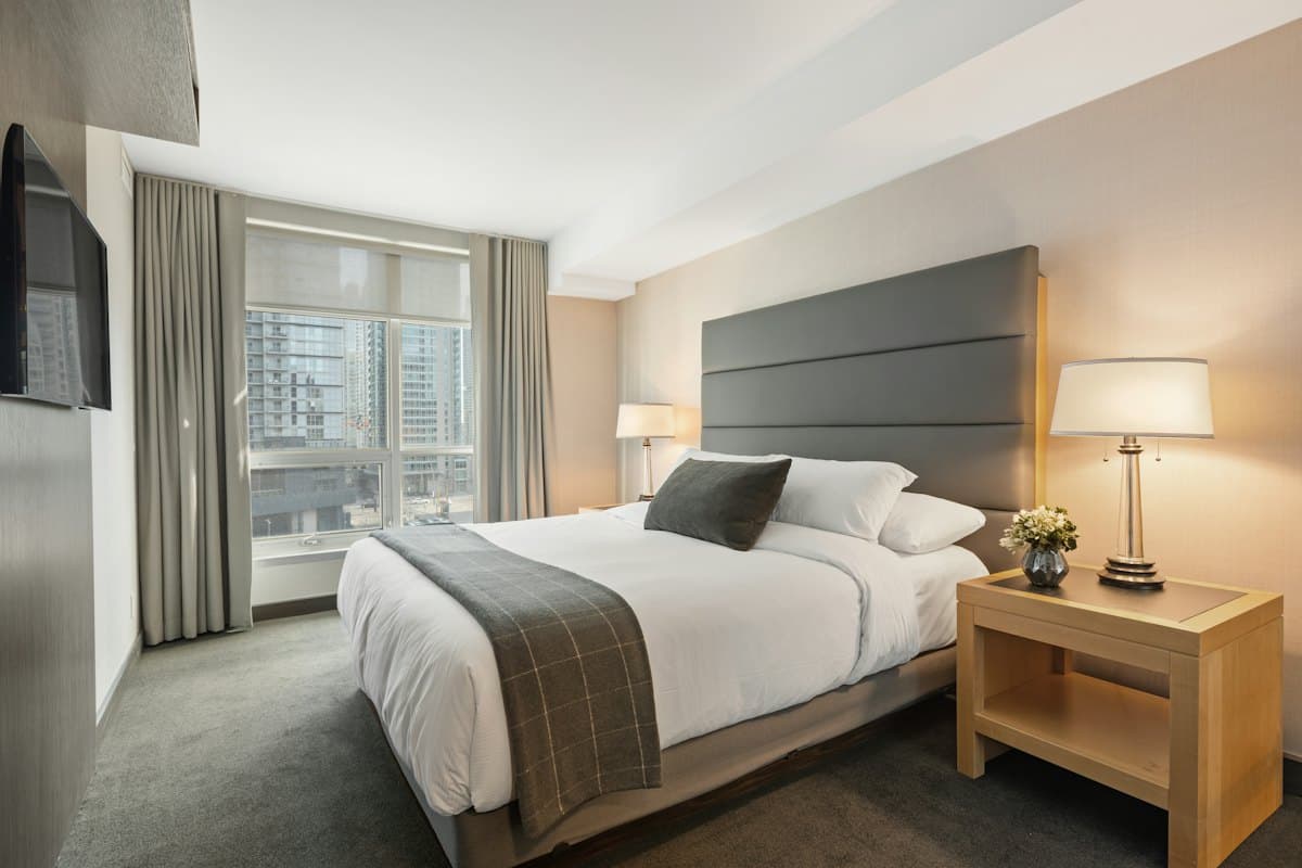 A clean, bright hotel room with a double bed