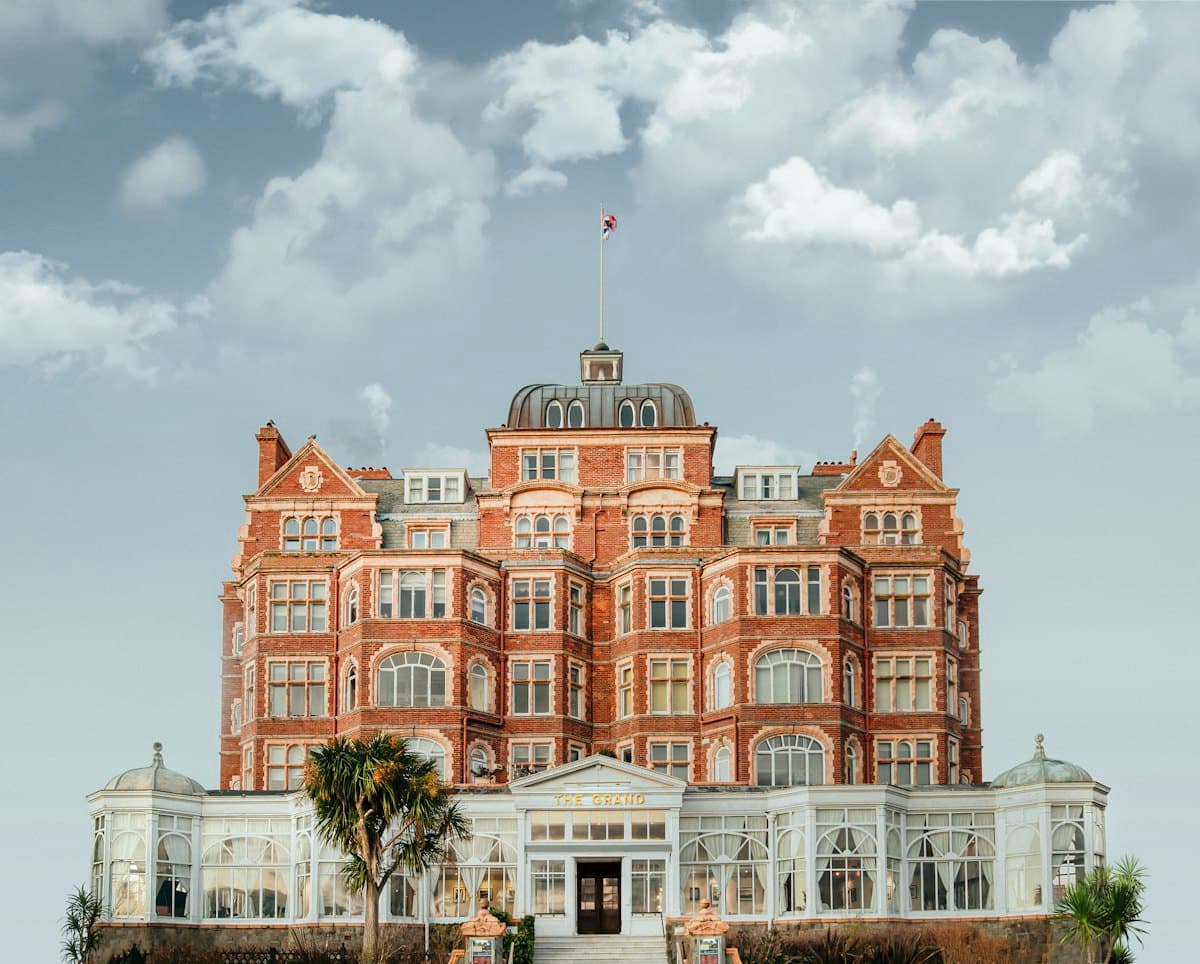 A grand heritage hotel facade under a blue sky