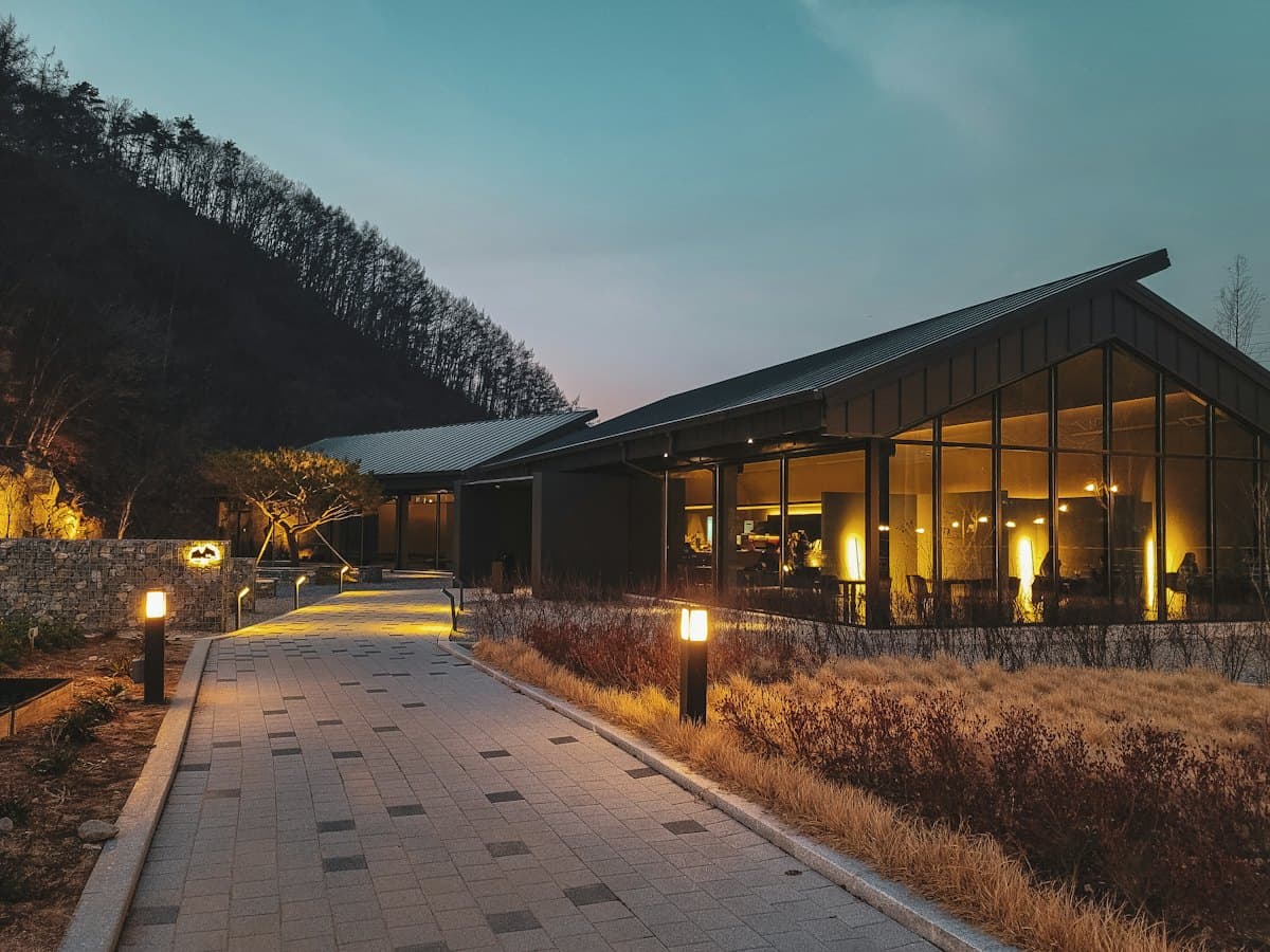 A mountain lodge lit up at dusk