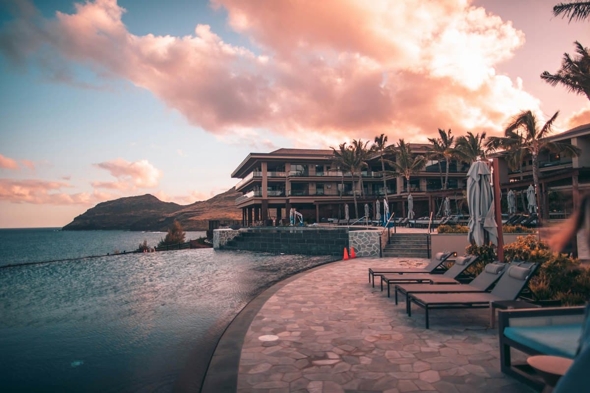 A resort with an infinity pool and loungers facing the sea