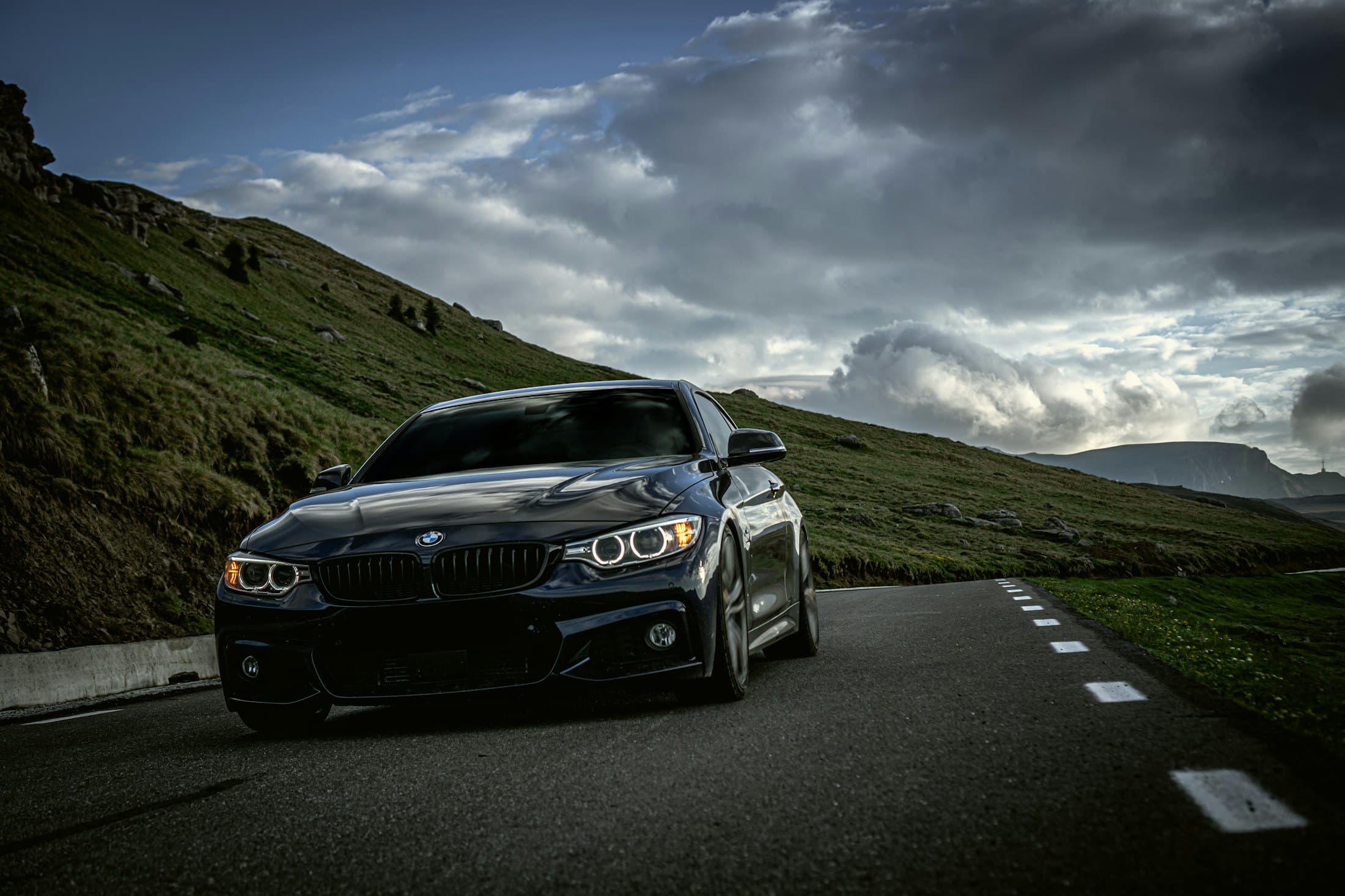 A premium sedan on a winding mountain road