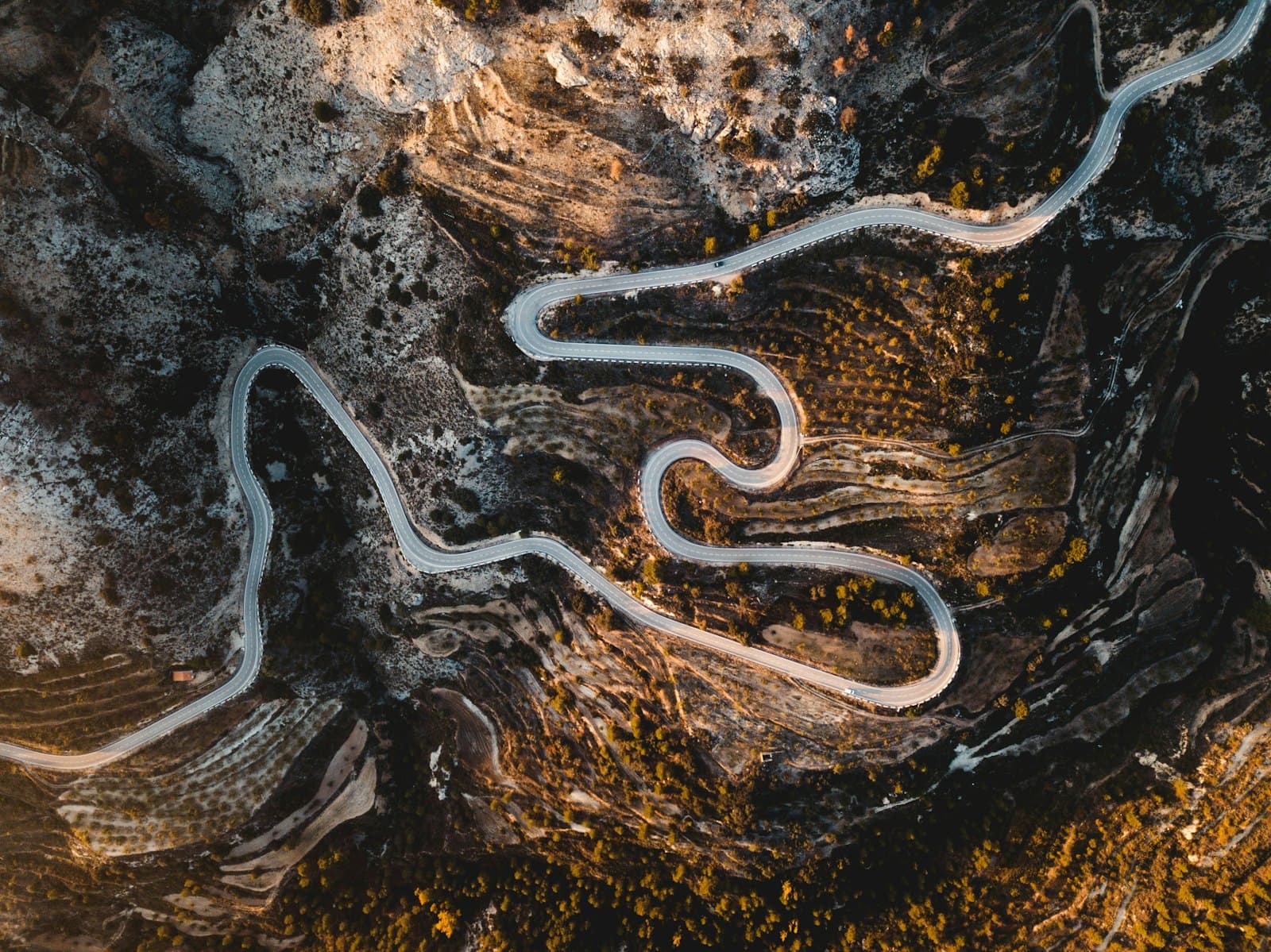 Aerial view of a winding road through the hills